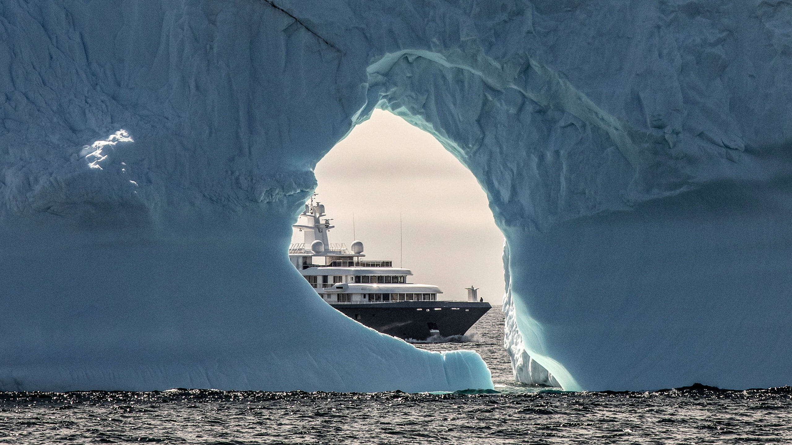 yacht behind iceberg