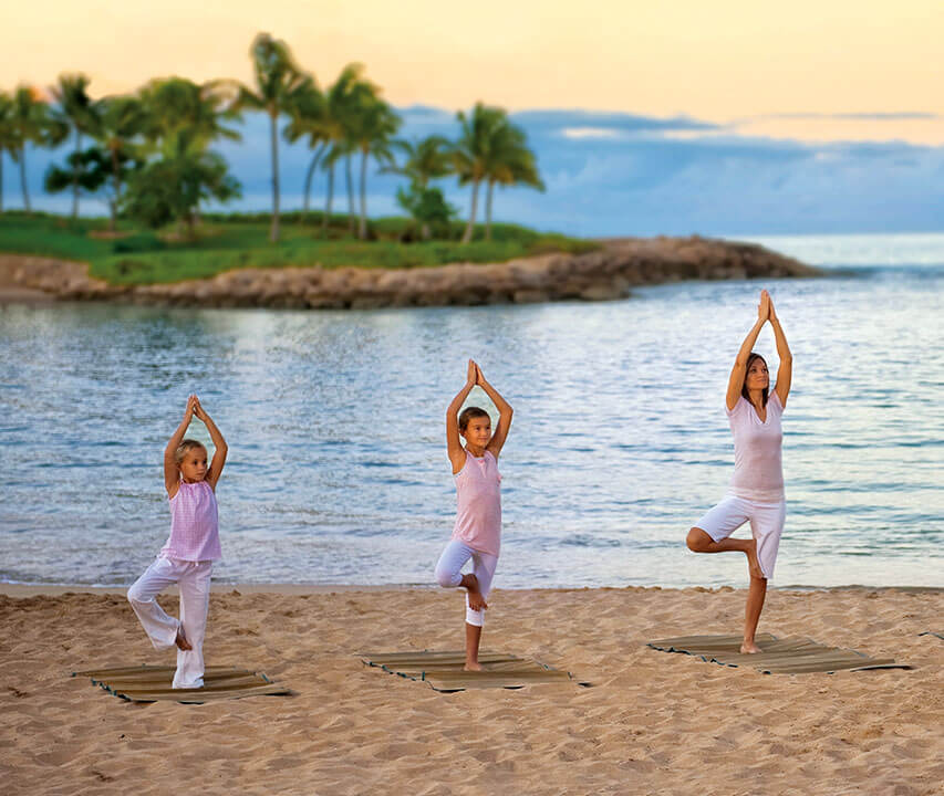 woman and two children doing yoga